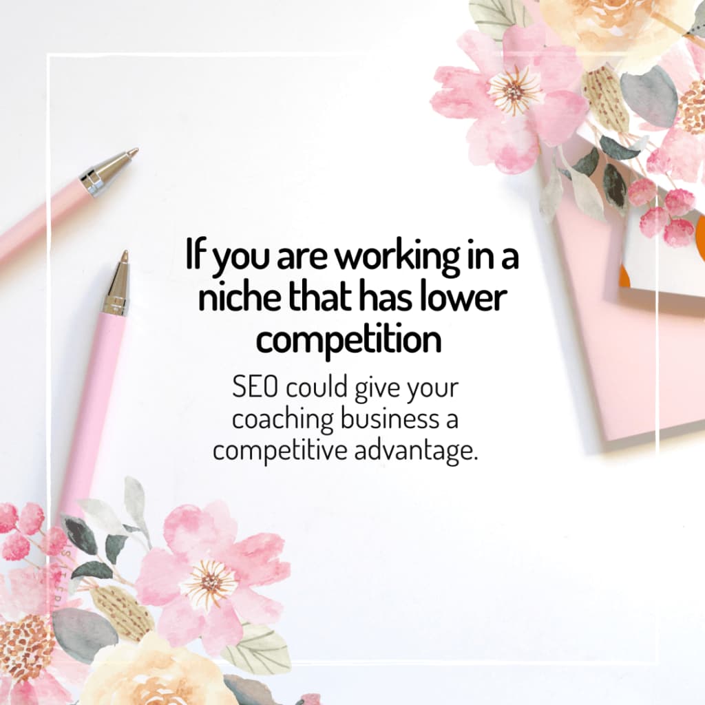 Floral stationery and pink pens accent a motivational business coaching tip about the benefits of low-competition niches for SEO for coaches.