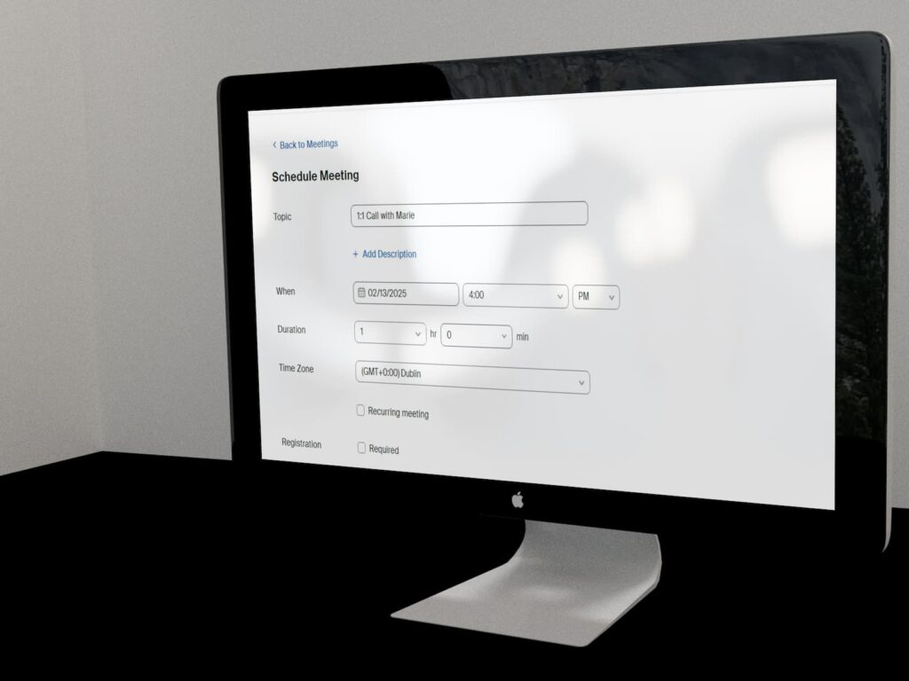 A computer screen showcasing Zoom online meeting software. The screen sits gracefully on a black desk.